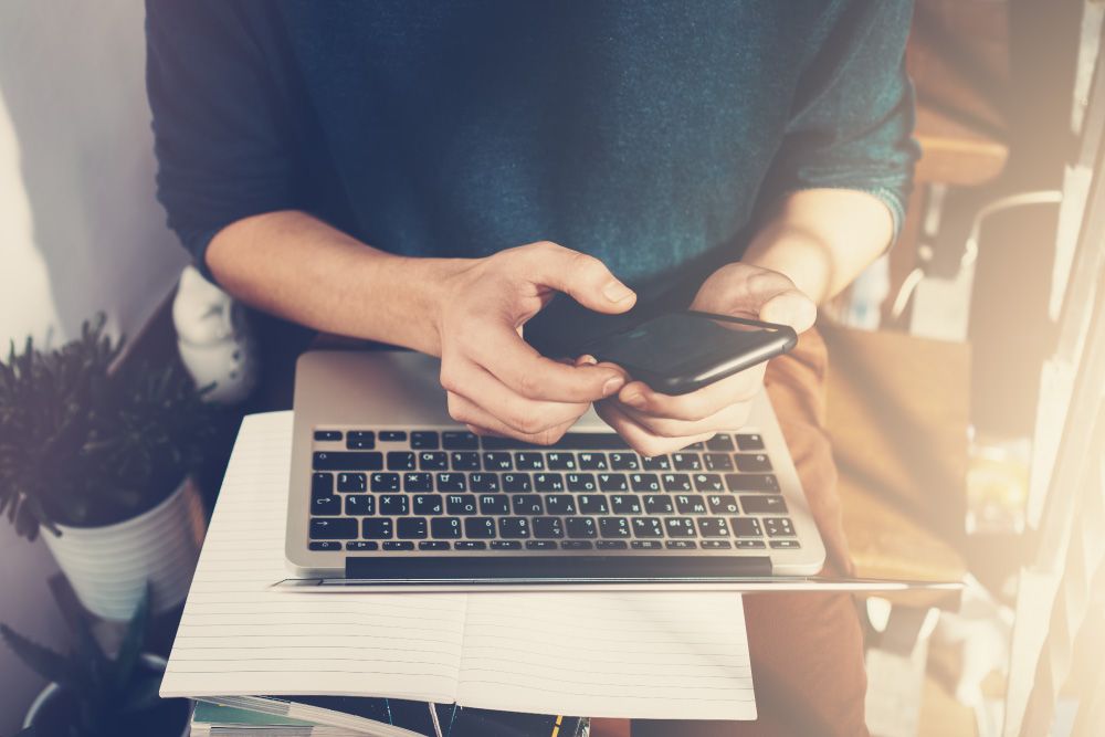 person using laptop and phone