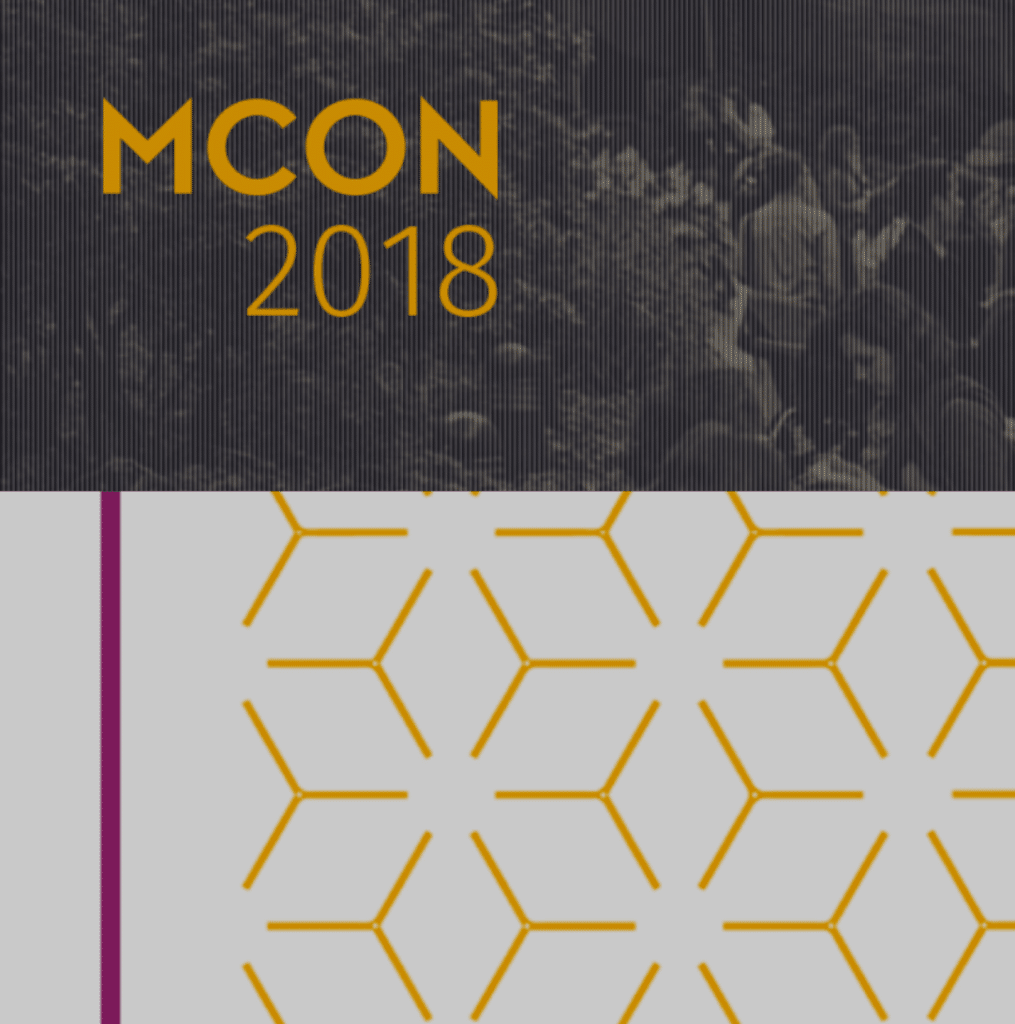 MCON 2018 written in yellow writing and yellow flower graphic below