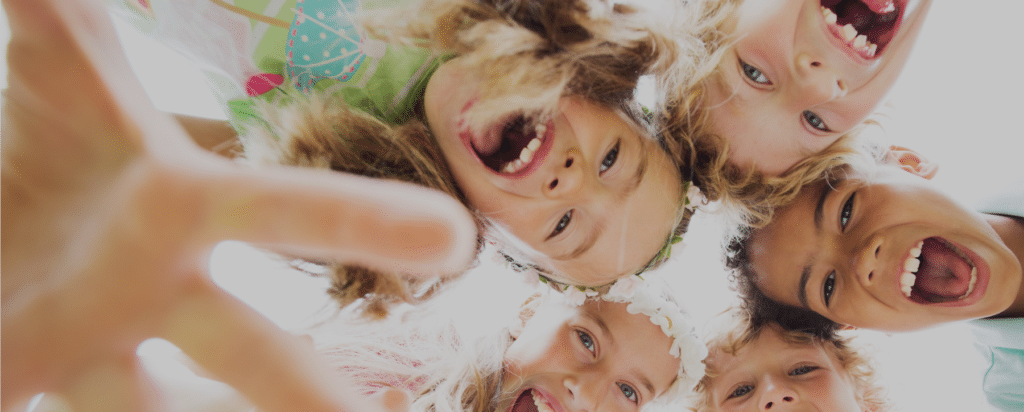 image of kids looking down at camera