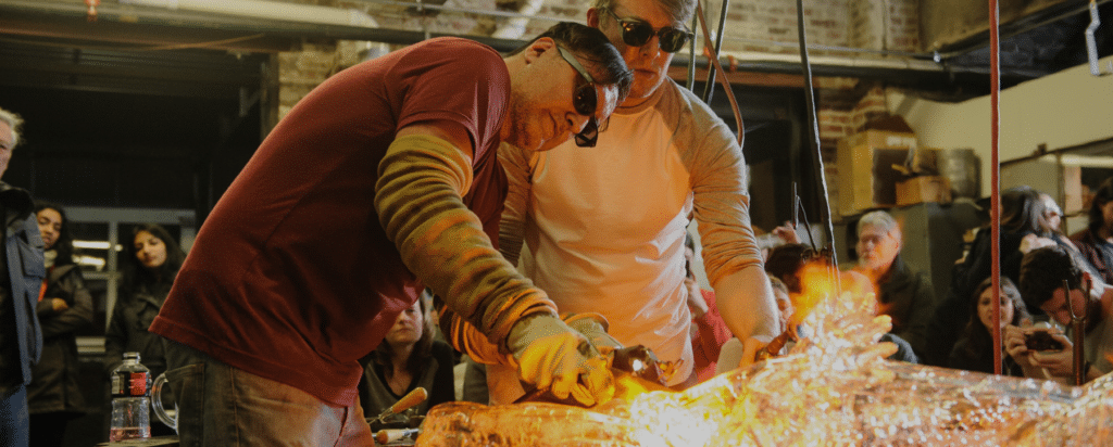 two people glass blowing