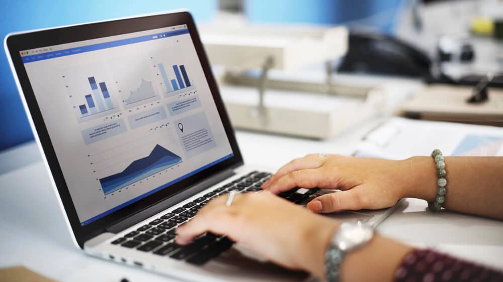 close up of hands working at a laptop